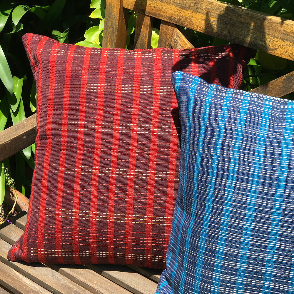 Phoebe cushion. Blue and navy blue stripes made with 100% organic cotton and natural dyes. Designed by Woven. Handmade in Guatemala.